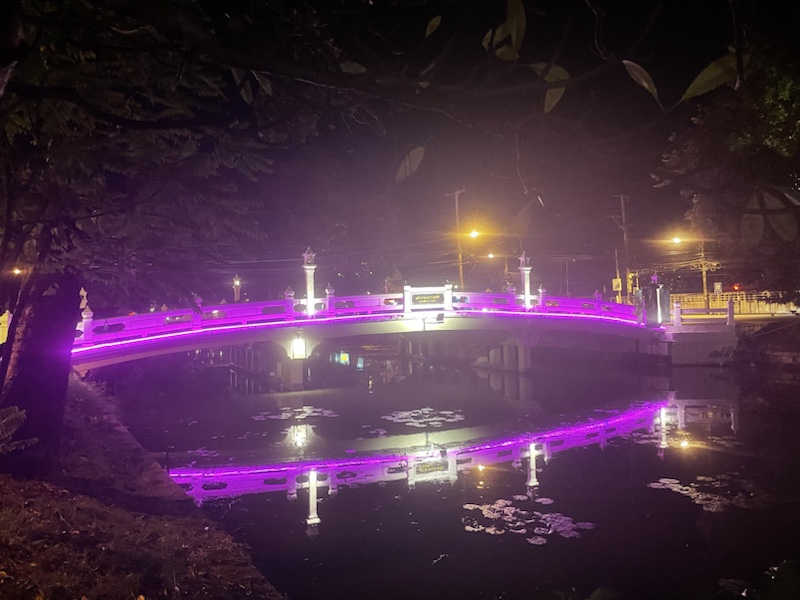 The bridge over the canal in Phitsanulok, Northern Thailand, looked pretty lit up at night​