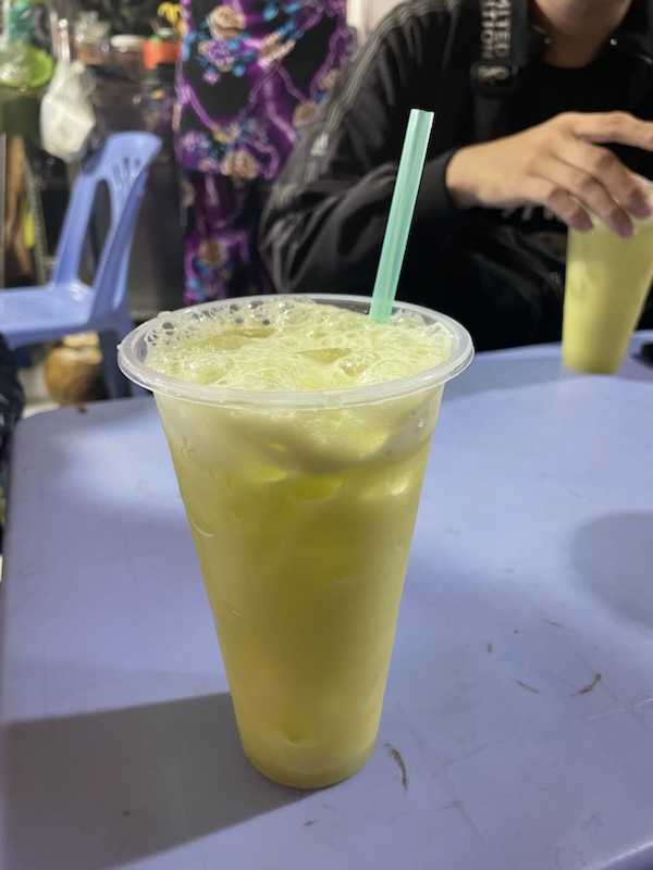 Sugar cane juice and coconut ice cream at Kem Bo, one of the street food market stalls in Ho Chi Minh City, Vietnam