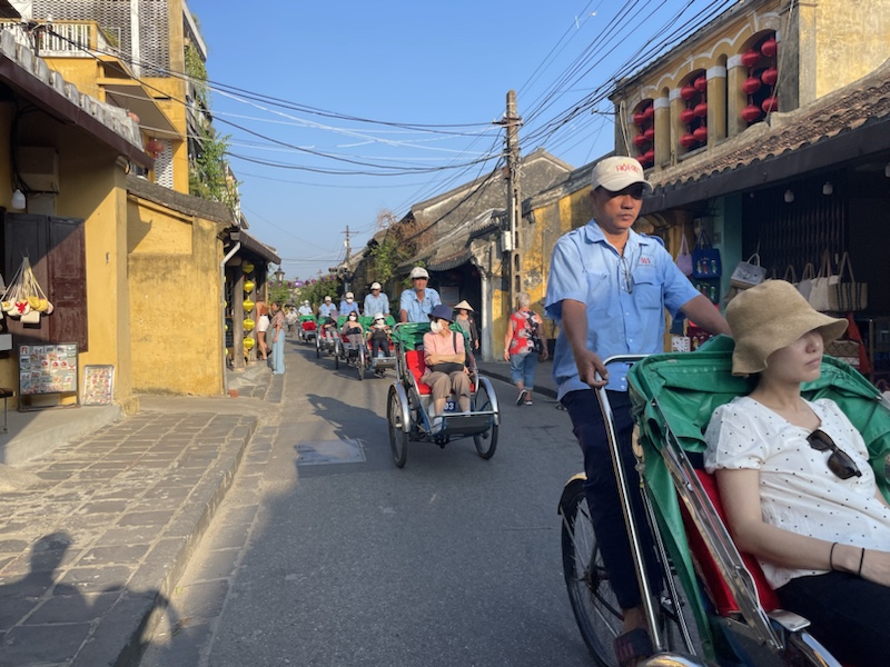 A long procession of bicycle rickshaws in Hoi An, Vietnam 