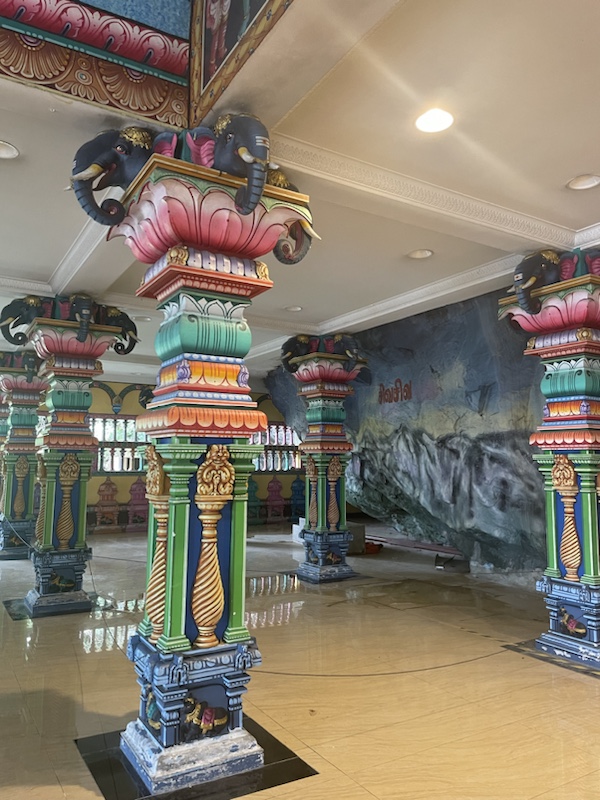 There’s a brightly coloured Hindu temple at the bottom of the steps ​to Batu caves, Kuala Lumpur, Malaysia 