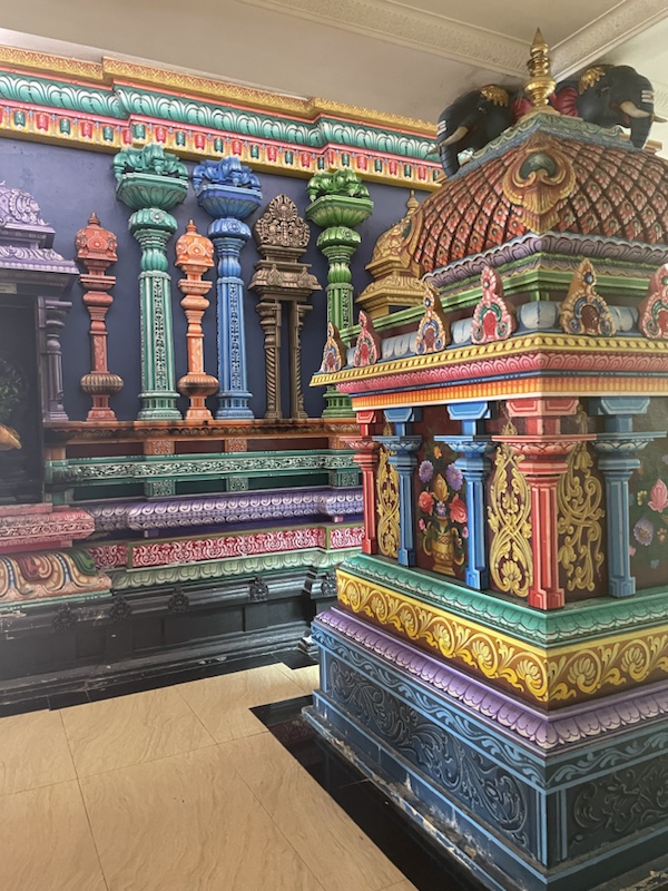 There’s a brightly coloured Hindu temple at the bottom of the steps ​to Batu caves, Kuala Lumpur, Malaysia 