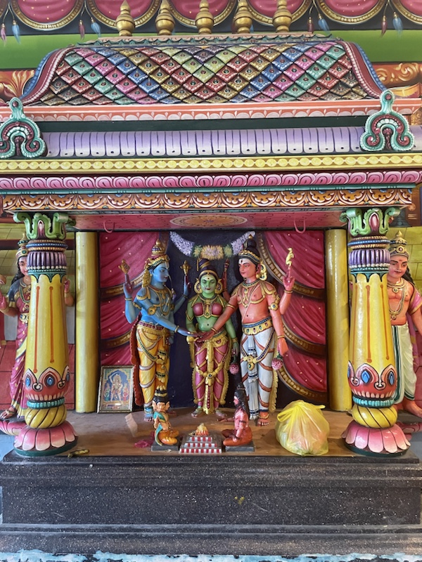 There’s a brightly coloured Hindu temple at the bottom of the steps ​to Batu caves, Kuala Lumpur, Malaysia 