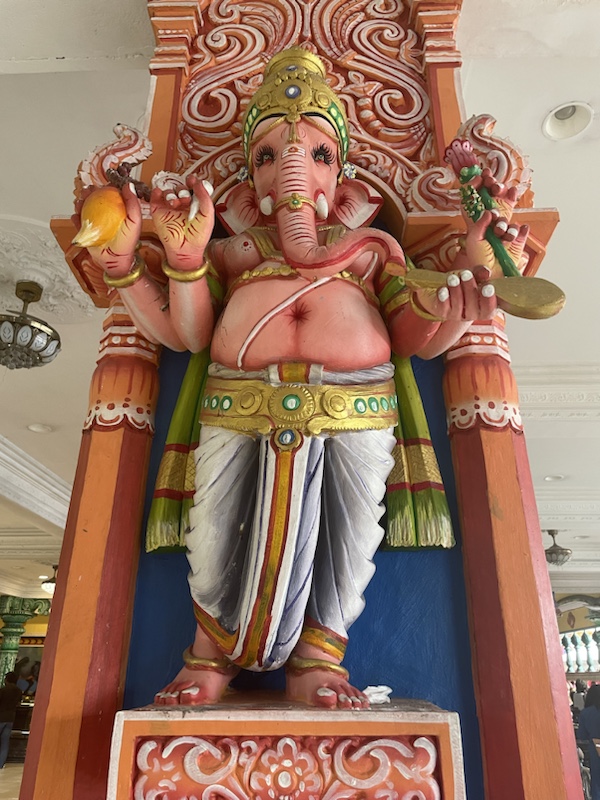 There’s a brightly coloured Hindu temple at the bottom of the steps ​to Batu caves, Kuala Lumpur, Malaysia 